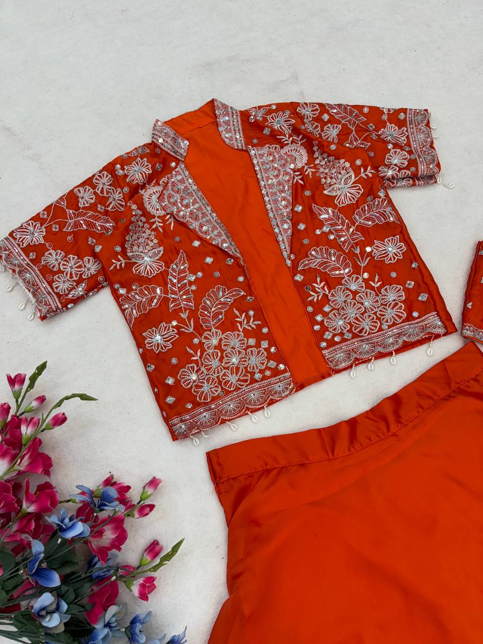 Experience effortless luxury with this premium Orange Lehenga choli With Heavy Traditional Jacket Expertly tailored with precise pleats and a refined finish, it delivers a sophisticated look without compromising comfort.